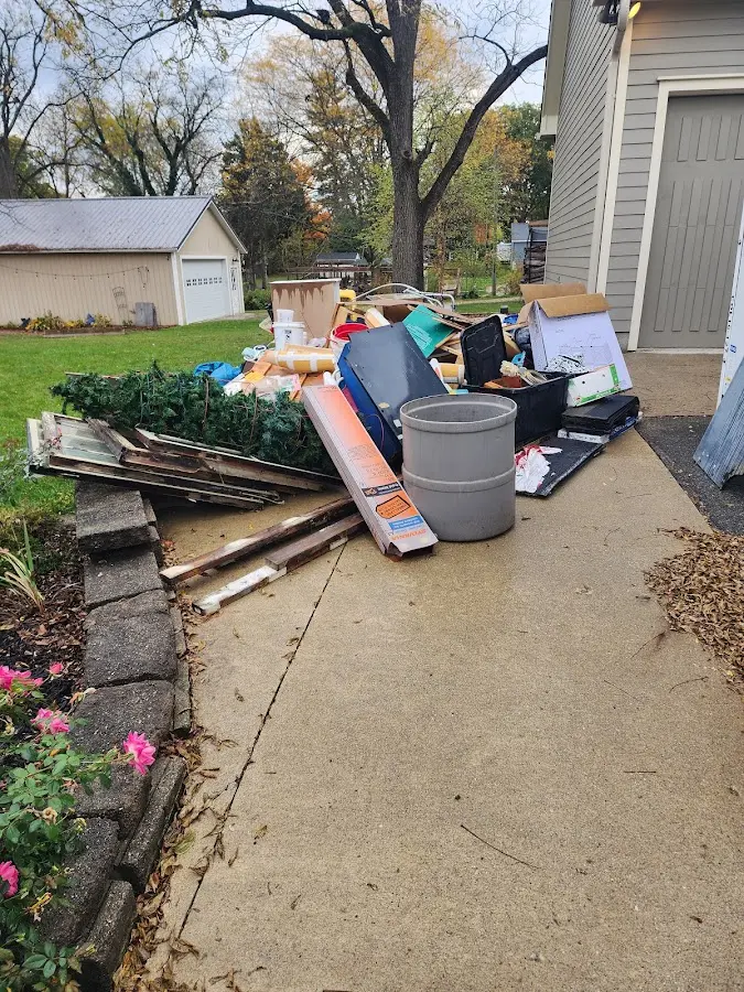 Dumpster being loaded with debris for Estate Cleanout Dumpster Rental in West Loch Estate